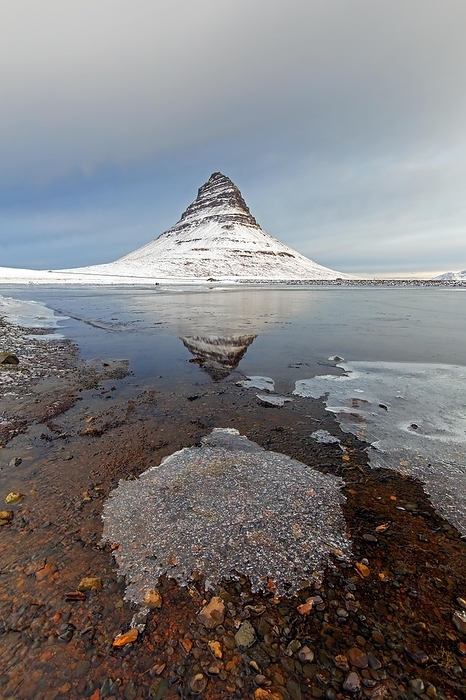 Iceland Kirkjufell, nunatak hill covered in snow reflected in water of fjord on the Sn fellsnes peninsula in winter, most photographed mountain in Iceland, by alimdi   Arterra   Sven Erik Arndt