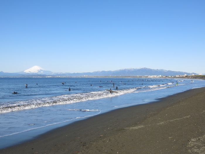 West beach of Katase coast in winter crowded with surfers (Mt. Fuji in the back left)