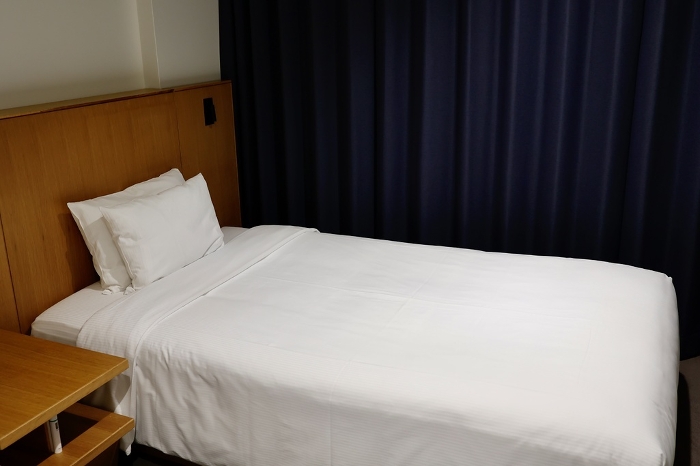 A pure white bed in a hotel