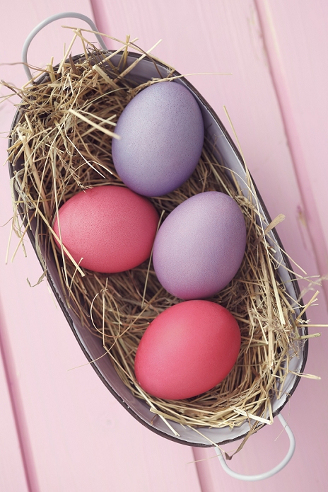 Coloful Easter eggs in basket, studio shot