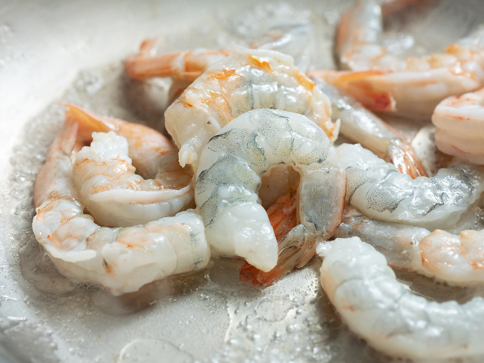 Frozen shrimp sauteed in a pan