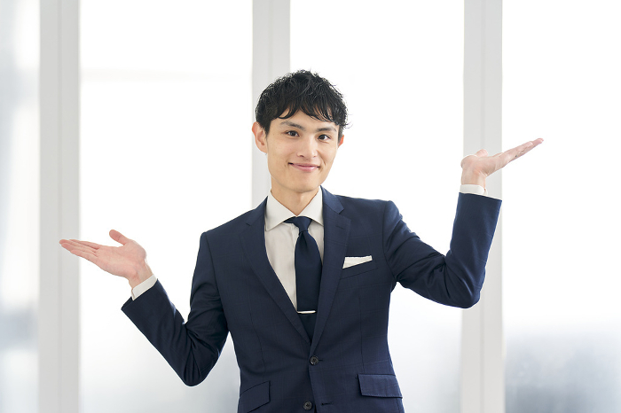 Japanese businessman comparing in a custom-made suit (Male / People)