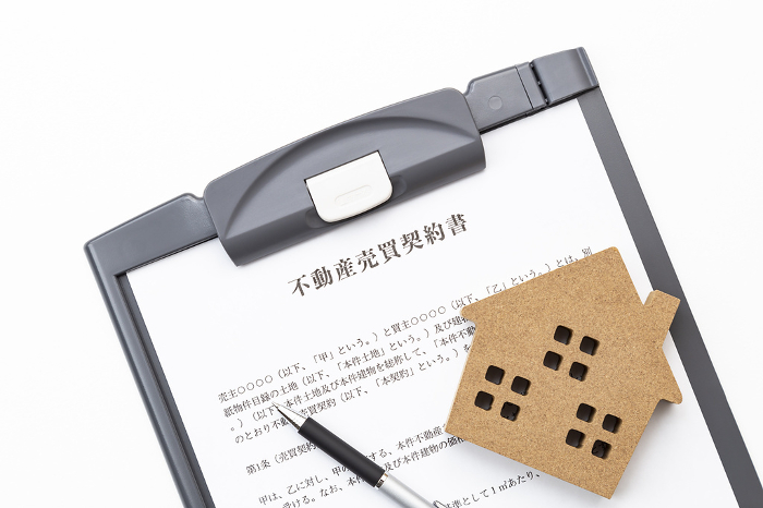 Real estate sales contract on white background