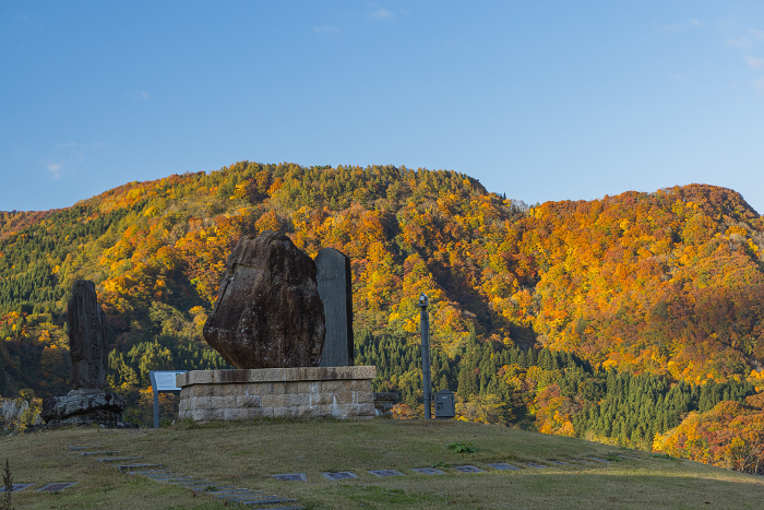 Stone monument and autumn leaves at Tsugaru Shirakami Lake Park in Nishimeya Village, Nakatsugaru-gun, Aomori Prefecture, Japan