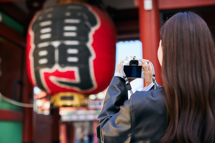 Japanese woman taking a picture with a camera