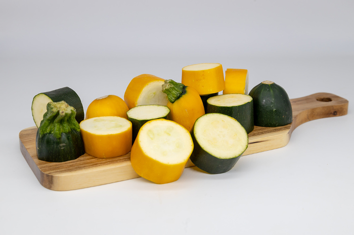 Zucchini sliced in rounds on a cutting board Green and yellow zucchini