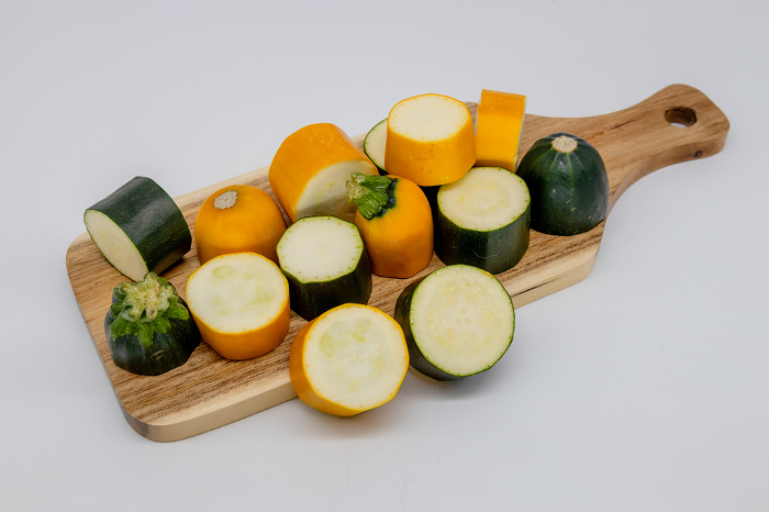 Zucchini sliced in rounds on a cutting board Green and yellow zucchini