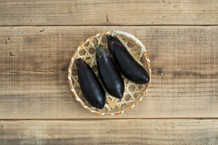 Eggplant on colander and wood background