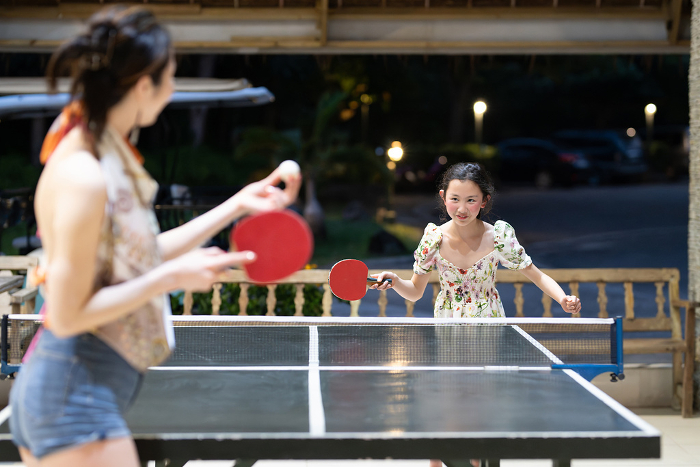 Parents and children playing table tennis