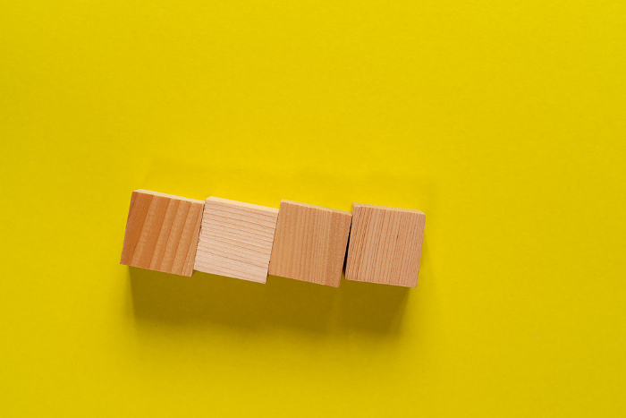 Blank blocks lined up on yellow background