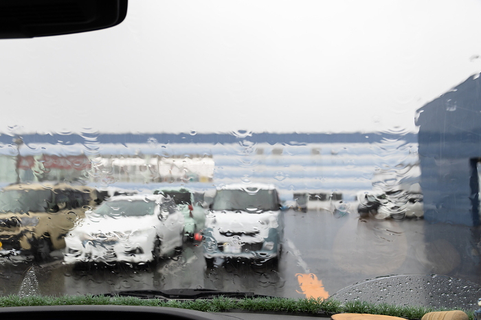 Parking lot on a rainy day seen from inside a car