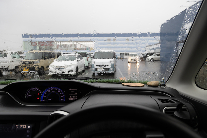 Parking lot on a rainy day seen from inside a car