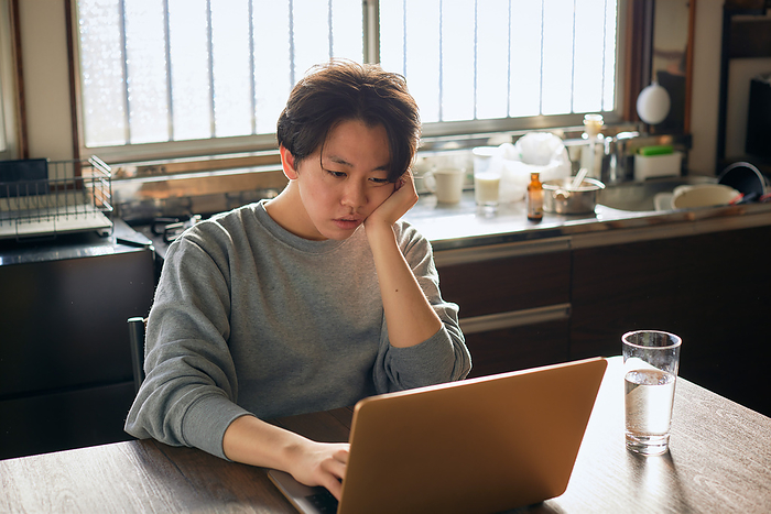 Japanese man working remotely in the kitchen