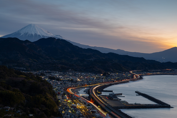 Morning glow, Mt. Fuji, and the light trail of automobiles Satta Pass