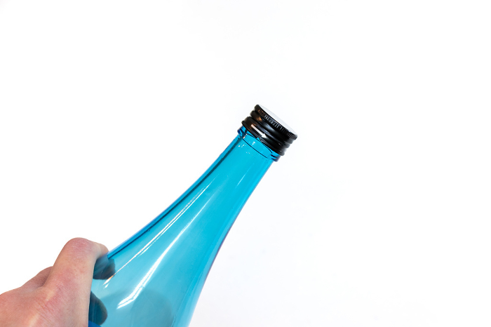 Mouth of glass bottle sealed with cap