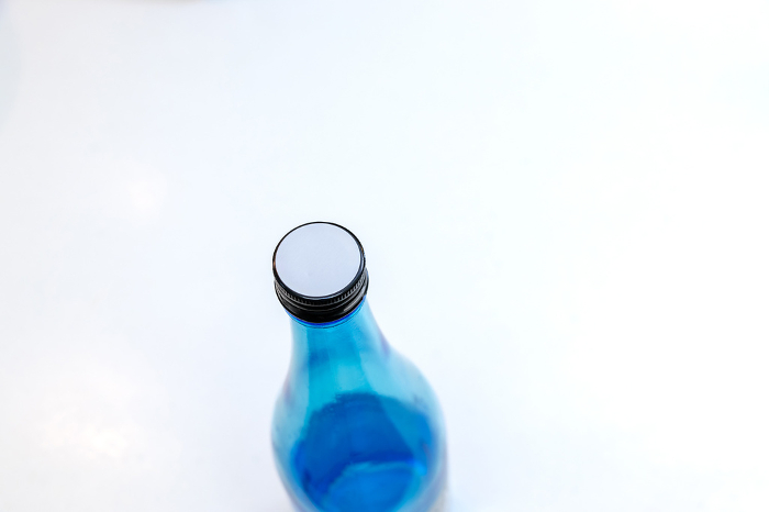 Blue glass bottle sealed with cap