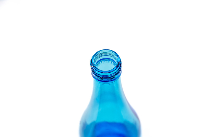 Empty glass bottle with cap removed