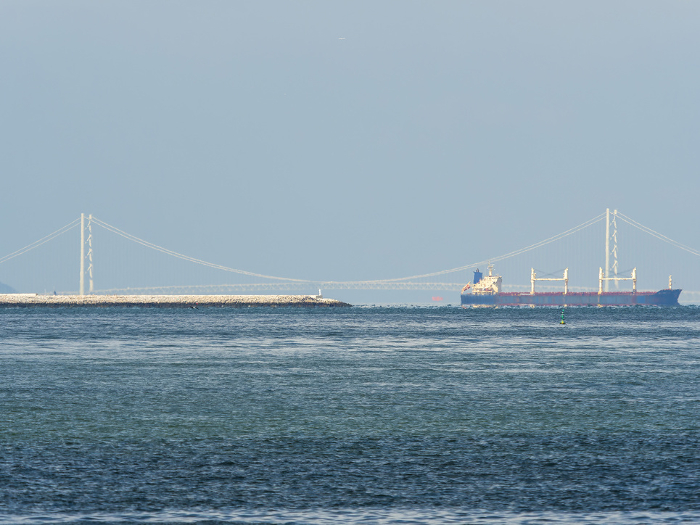 Akashi Kaikyo Bridge and empty container ships seen from Osaka Port