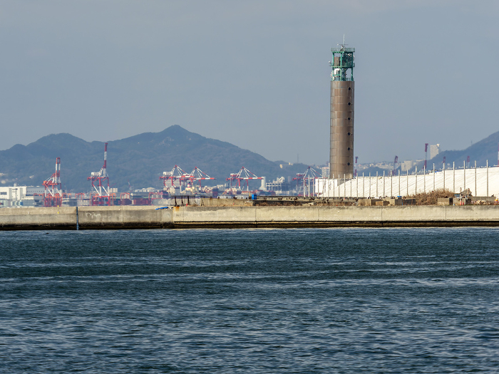 Osaka Lighthouse on the breakwater at Osaka Port and container yard at Kobe Port