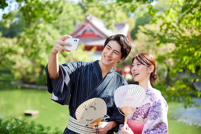 A Japanese couple in yukata taking a selfie