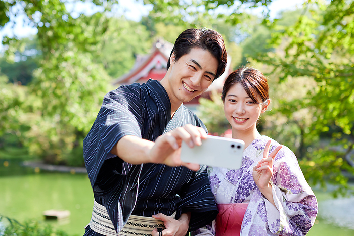 A Japanese couple in yukata taking a selfie