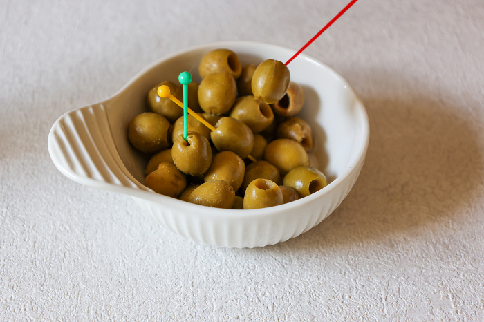 Olive oil pickles in a white ceramic bowl