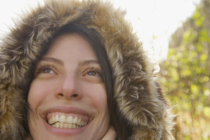 Close up of a smiling woman wearing a hooded parka