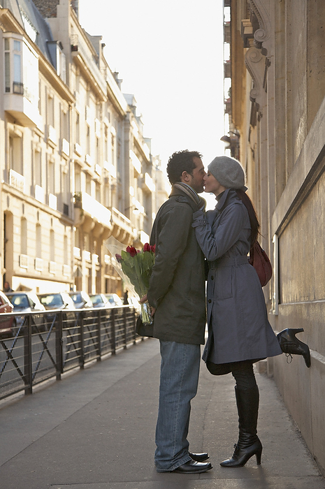 Young couple kissing in a city street