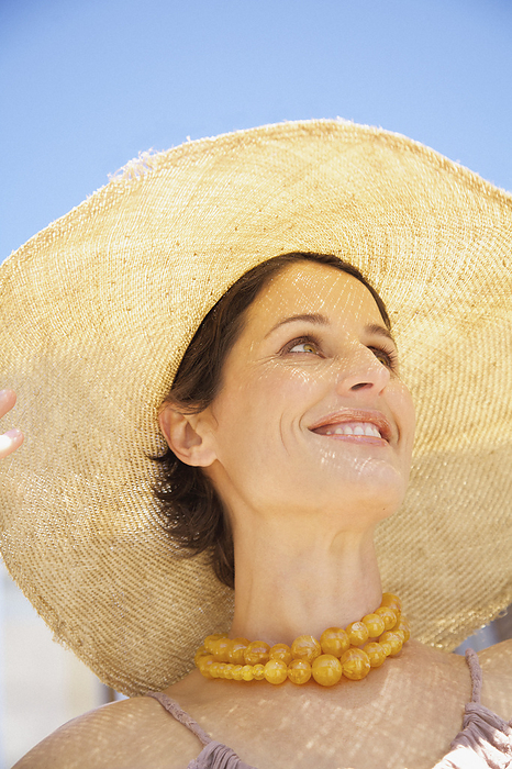 Close up of a woman wearing a straw hat