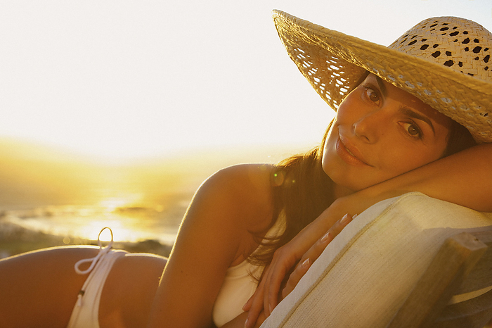 Woman Wearing Straw Hat Lying on Sun Lounger
