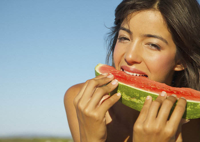 Young Woman Eating Watermelon