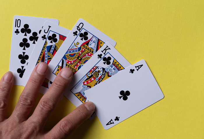 A person holding a playing card