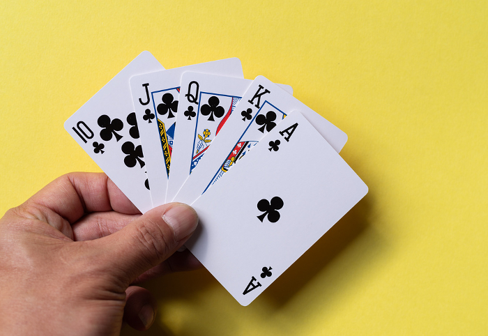 A person holding a playing card