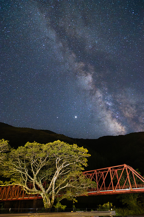 The Milky Way over the  Red Iron Bridge,  a Kitagawa Village Forest Railroad Site The Milky Way over Kojima Bridge, commonly known as the old forest railroad in Kitagawa Village, Kochi Prefecture. A summer scene.  Non synthetic, one shutter shot 