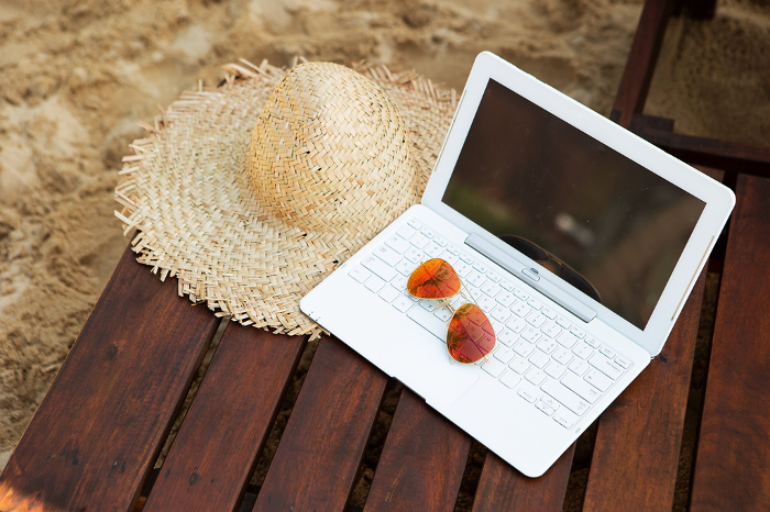 Straw hat and laptop