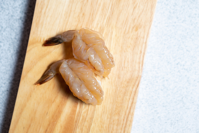 Raw shrimp sushi on cutting board