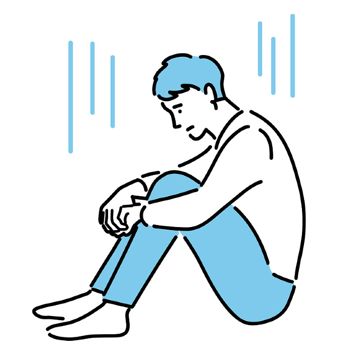 A young man crouched down and depressed