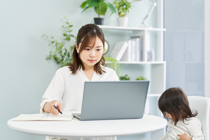 Japanese woman working from home while raising children (People)