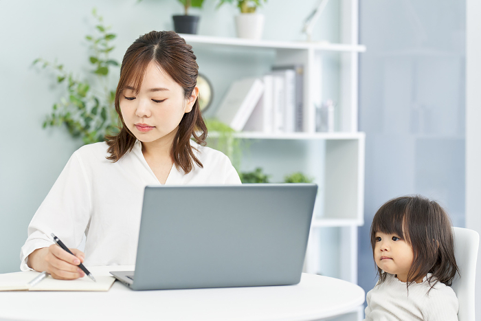 Japanese woman working from home while raising children (People)