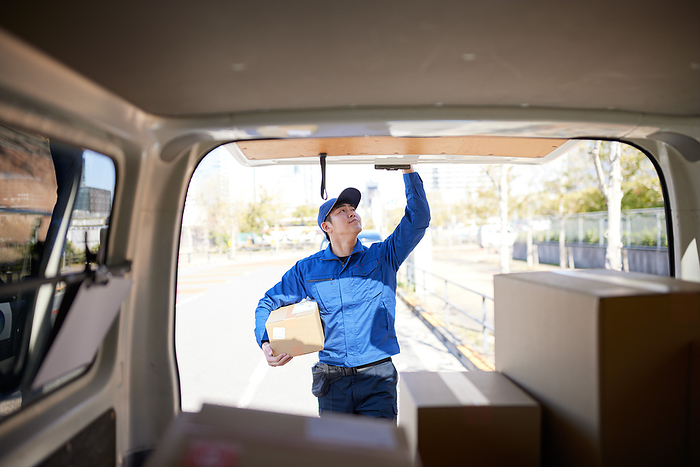 Delivery person opening and closing the cargo door