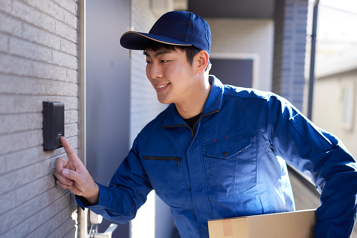 delivery person pushing an intercom