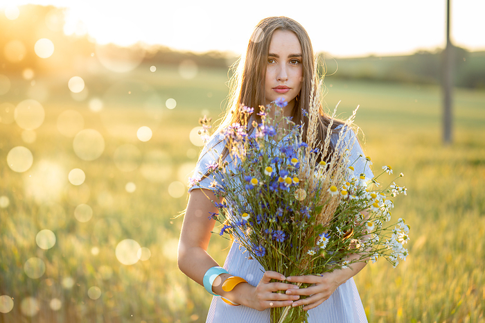 Woman with bouquet of flowers in a field Woman with bouquet of flowers in a field., by WLADIMIR BULGAR SCIENCE PHOTO LIBRARY