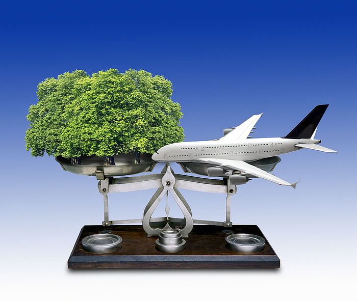 Offsetting carbon emissions, conceptual image Offsetting carbon emissions. Conceptual image showing an aeroplane balanced on a set of scales against trees. This represents the environmental strategy known as  carbon offsetting . This strategy involves the planting of trees  which absorb carbon dioxide  to offset the release of carbon dioxide elsewhere. Carbon offset credits can be traded between companies to meet their targets. Carbon dioxide is the main greenhouse gas that contributes to man made global warming. Emissions from aviation are a significant contributor to climate change., by VICTOR de SCHWANBERG SCIENCE PHOTO LIBRARY