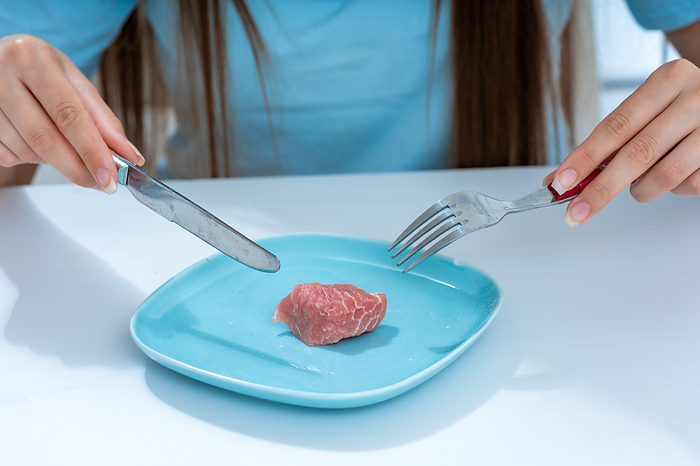 Raw red meat on plate Raw red meat on plate. This could represent the negative health impacts of red meat., by WLADIMIR BULGAR SCIENCE PHOTO LIBRARY