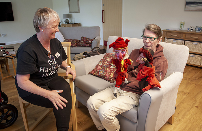 Care home resident with puppets Care home resident playing with a pair of puppets., by JOHN COLE SCIENCE PHOTO LIBRARY