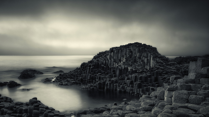 Giant s Causeway in fog, Northern Ireland, UK Giant s Causeway shrouded in fog in County Atrim, Northern Ireland, UK. This large stretch of 40,000 black basalt columns is the result of cooled lava from volcanic eruptions that took place over 5o million years ago., by JEREMY WALKER SCIENCE PHOTO LIBRARY