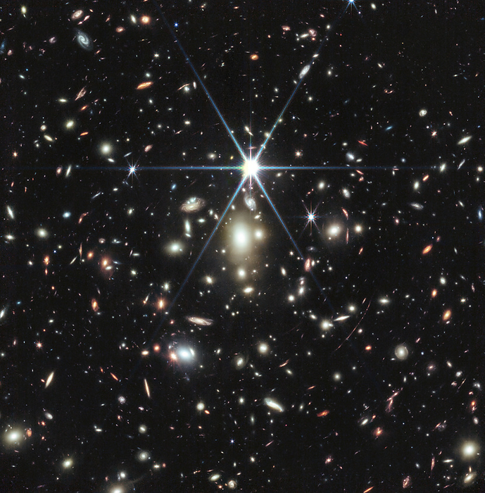 Sunrise Arc galaxy, JWST image James Webb Space Telescope  JWST  image of a massive galaxy cluster WHL0137 08 containing the Sunrise Arc galaxy. The fuzzier, white galaxies at the center of the image are part of the galaxy cluster bound together by gravity. The various redder, curved galaxies are background galaxies picked up by Webb s sensitive mirror. Image captured by JWST s Near Infrared Camera  NIRCam . , by NASA ESA CSA SCIENCE PHOTO LIBRARY