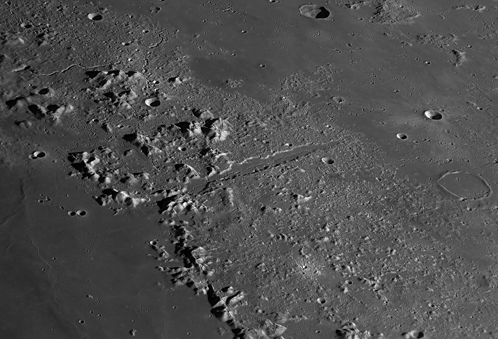 Lunar valley Vallis Alpes Vallis Alpes  diagonal line, centre , a lunar valley. This valley bisects the Montis Alpes  lunar alps , a mountain range formed by an object impacting the Moon. Vallis Alpes is 166 km long, extending from Mare Imbrium basin to the edge of the Mare Frigoris. Its maximum width is around 10 km., by DAMIAN PEACH SCIENCE PHOTO LIBRARY