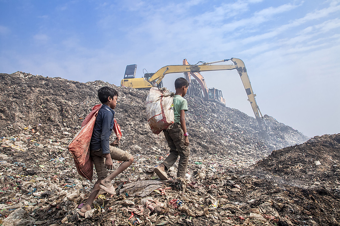 Child labourers working in rubbish dump Child labourers working in a rubbish dump in Chittagong, Bangladesh. They collect recyclables in hazardous conditions for meagre pay to deposit them in scrap shops. Photographed on 12 February 2024., by MUHAMMAD AMDAD HOSSAIN SCIENCE PHOTO LIBRARY