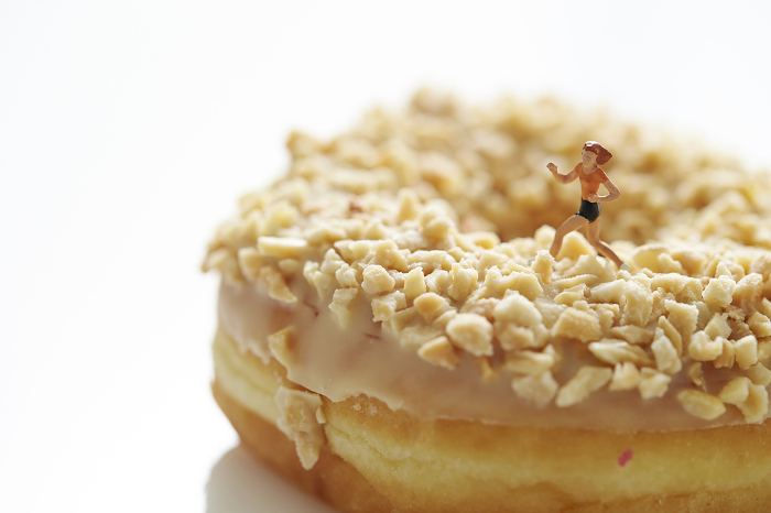 Miniature figure of a woman running with donuts
